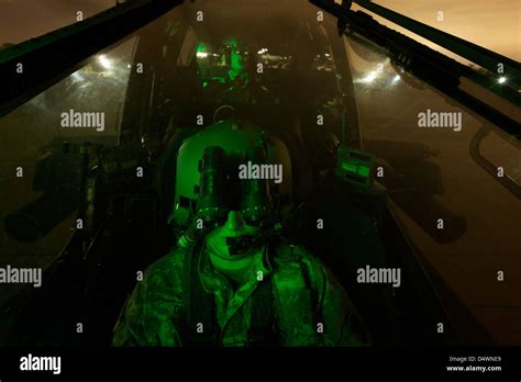 pilot equipped  night vision goggles   cockpit   ah  apache helicopter stock