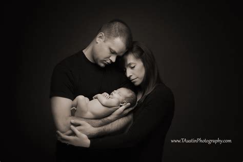 husband  wife holding  newborn baby  studio photography  maternity