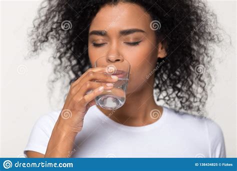Healthy Thirsty African Woman Drinking Water Isolated On
