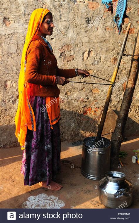 Indian Woman Churning Butter In Her Tribal Village Madhya Pradesh India