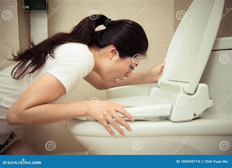 Closeup Of Young Pretty Woman Vomiting Into Toilet Royalty Free Stock