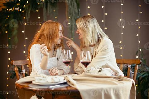 Lesbian Couple Having Dinner In A Restaurant Girls Drink Wine And Talk