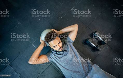 Handsome Black Man Lying On Floor Working Out With A Med Ball His Abs