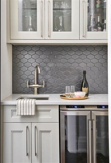 light gray  black butlers pantry boasts black honeycomb backsplash tiles merg kitchen