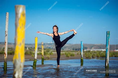 woman   hand  big toe yoga pose   beach tarifa cadiz
