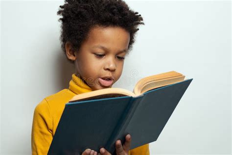 african american child boy reading  book  white background black kid student portrait