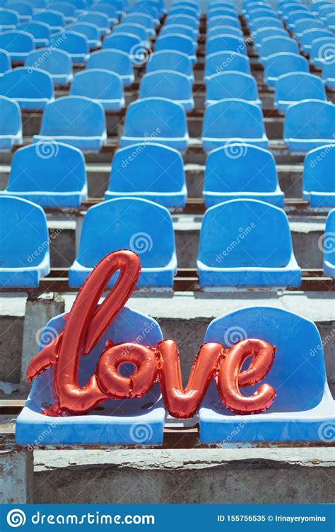 love red foil balloon on blue stadium seats letter shaped balloons