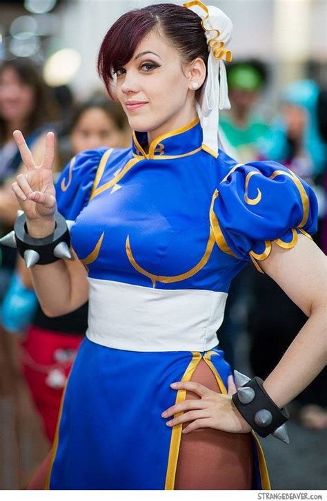 a woman dressed in blue and white is making the peace sign