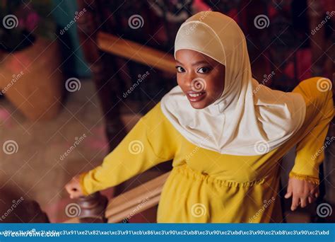 Beautiful Muslim Girl In Hijab Smiling Waiting For Her Food In A