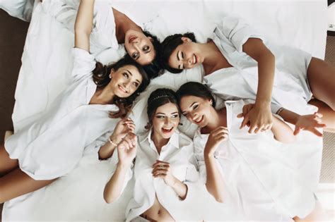 free photo sexy bride and bridesmaids lying in bed before