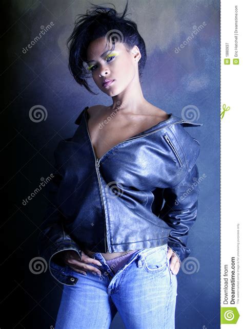 teenage african american girl wearing a leather jacket showing her