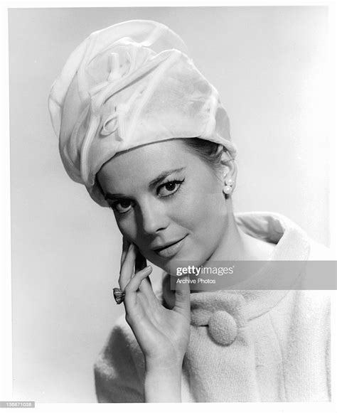 natalie wood wearing a tall white hat with a wool jacket