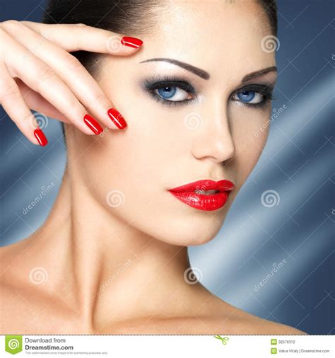 beautiful woman with red nails and blue eyes stock