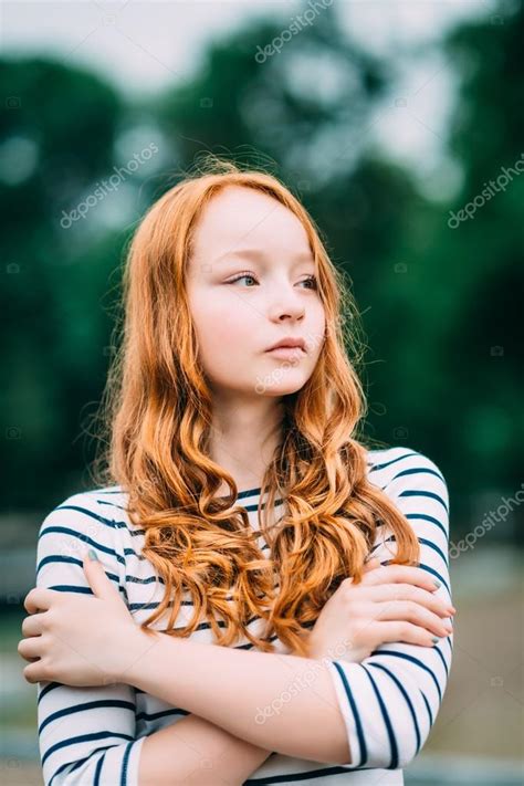 Outdoor Portrait Of Pretty Red Haired Girl With Green Eyes