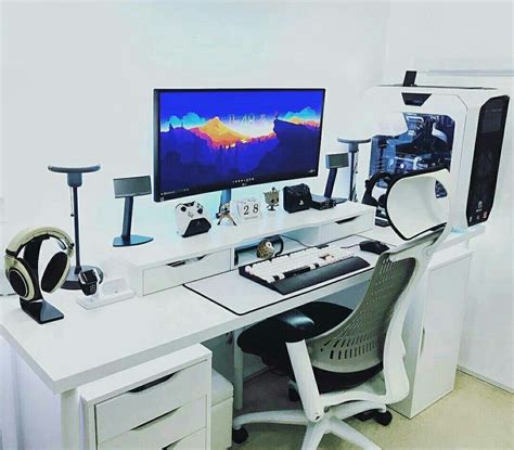white desk   computer  headphones    front   wall