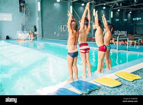 jungen sportlichen uebungen mit haenden  der naehe von pool ansicht von hinten sportliche