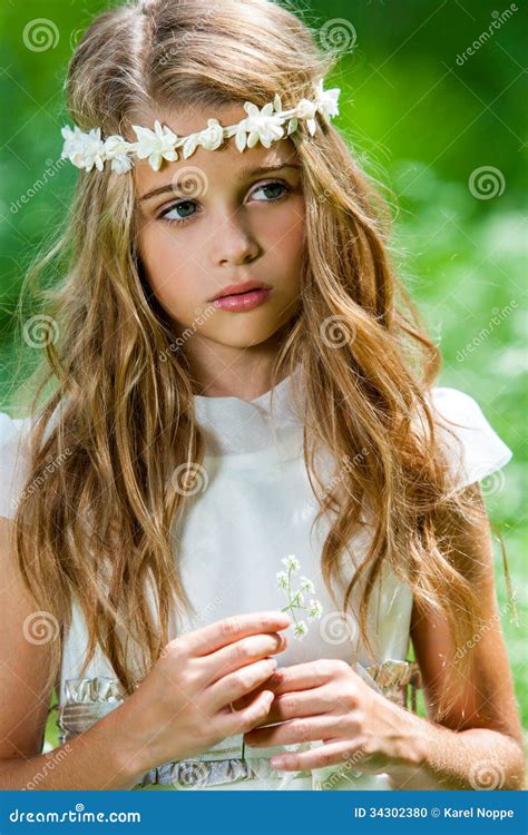 cute girl  white dress holding flower stock photo image