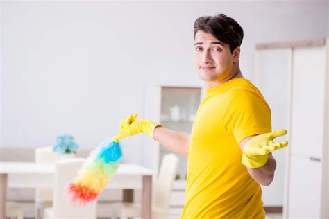 premium photo man husband cleaning the house helping his wife