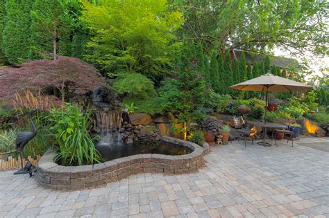 backyard garden landscaping  waterfall pond  beautiful hardscape patio champion brick