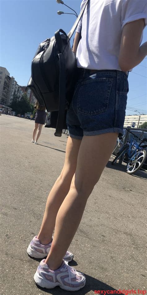 cute gilr with thin legs in blue denim shorts street