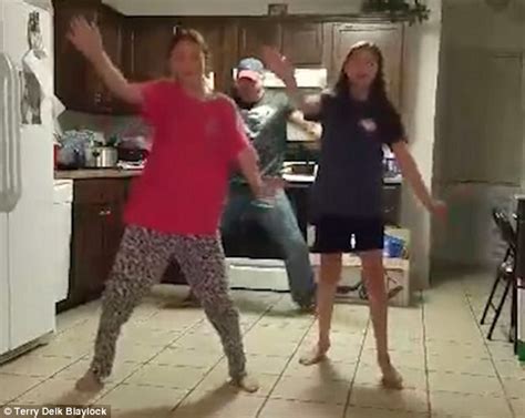 father of two girls practising the whip nae nae sneaks up behind them