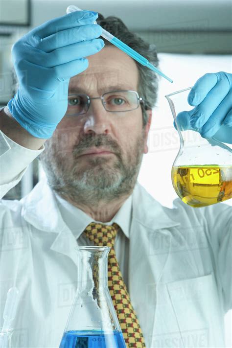 scientist mixing liquid  laboratory stock photo dissolve