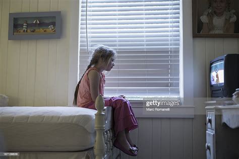 caucasian girl watching television on bed photo getty images