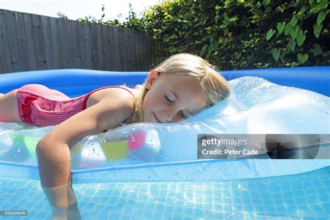 Girl Eyes Closed Laying On Lilo In Paddling Pool Photo Getty Images