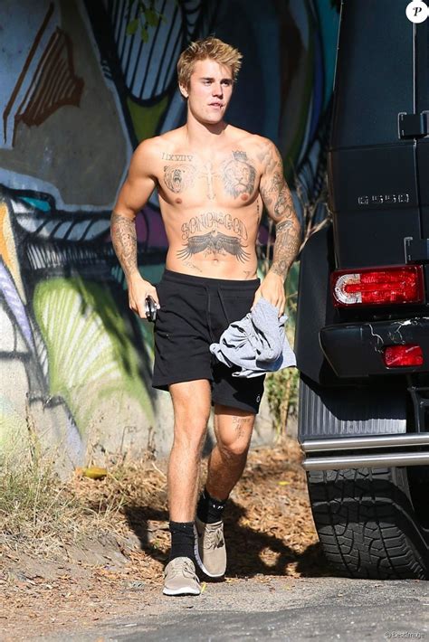 justin bieber half naked he proudly displays his muscular