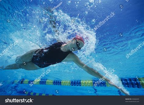 female swimmer racing underwater  pool stock photo