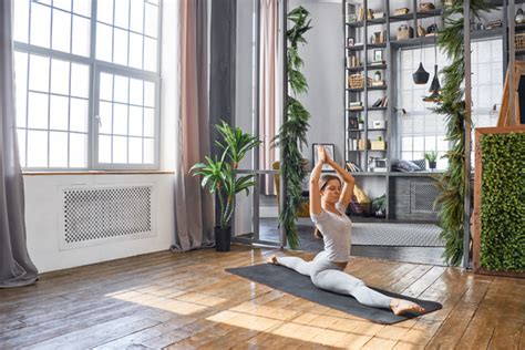 woman practicing yoga   living room stock photo