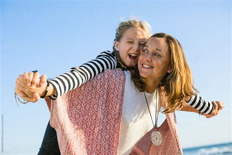 Mother And Her Daughter Enjoying A Sunny Autumn Day On The Beach Del