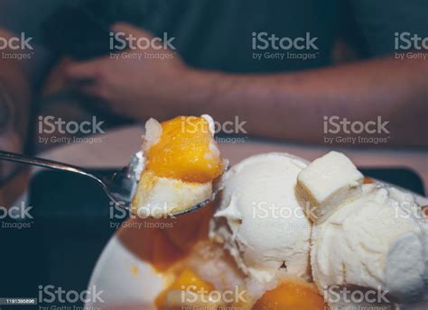 Close Up View Of Spoon Filled With Mango Bingsoo Korean Shaved Ice