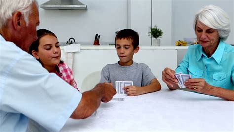 grandson and grandmother playing cards having fun