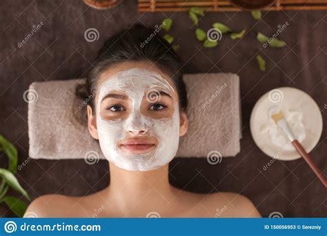 young woman  face mask relaxing  massage table  spa salon top