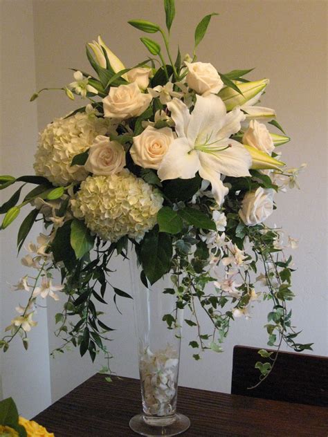 centerpiece white roses hydrangea orchids tall vendela  blue orchid dendrobium ivy