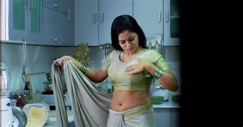 woman   white sari     fabric   skirt  standing   kitchen