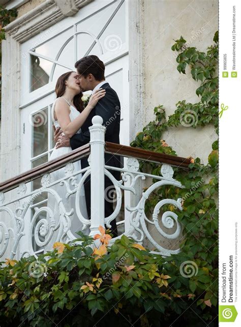 Low Angle View Of Couple Kissing While Standing In Balcony Stock Image