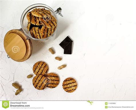 cookies polished with chocolate and peanut pieces in a glass jar with a