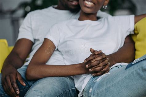 Cropped Shot Of Young African American Couple In White T Shirts Holding