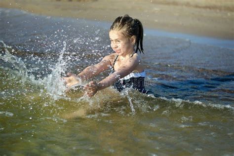 adorable  girl  splashing  smashing sea water   fun