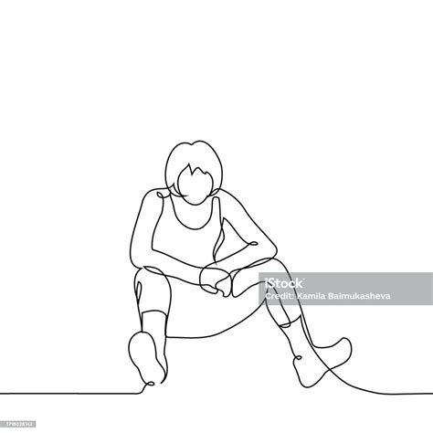 Woman Sits On The Floor With Her Legs Spread Wide Elbows On Her Knees