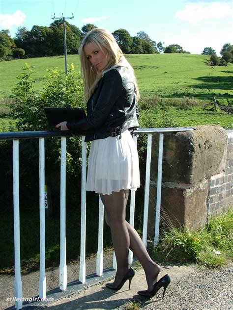 gorgeous blonde erin is outdoors showing off her shiny legs covered in silky nylon seduction