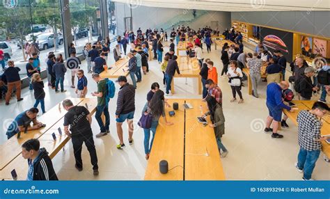 customers browsing  latest apple products   apple store san francisco california