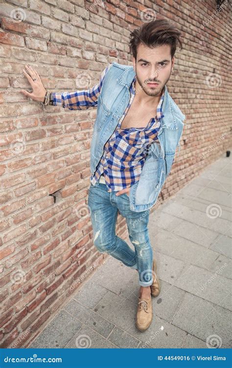 man leaning   hand   wall stock photo image  outdoor