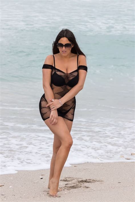 claudia romani poses on south beach in a small black thong