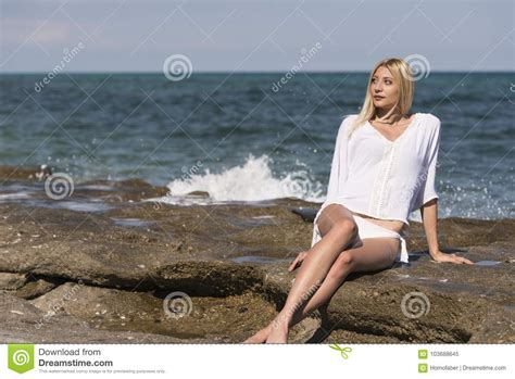 Βlonde Woman Sitting On Sea Rocks Stock Image Image Of Skinny Stone