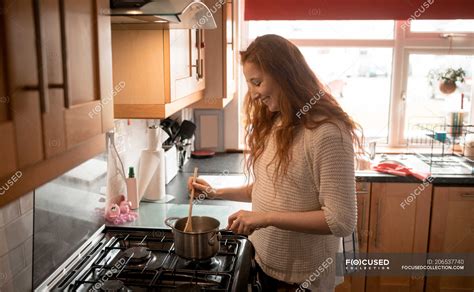 Beautiful Woman Cooking Food In Kitchen At Home — Self Isolation Day