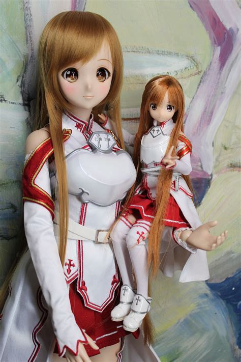 Two Dolls Are Posed Next To Each Other