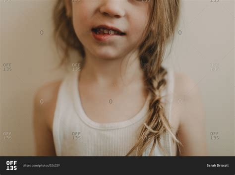 cute young girl biting  lip stock photo offset